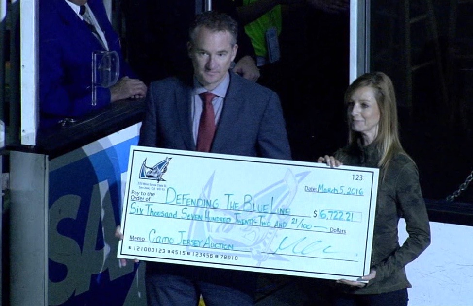 Cathy Andrade receiving DTBL check from Sharks