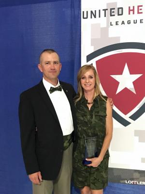 Cathy receiving an award from United Heroes League